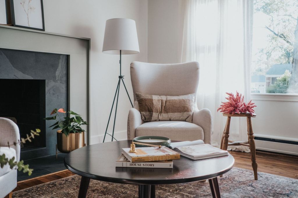 Reading corner with tripod lamp, wingback chair and round coffee table
