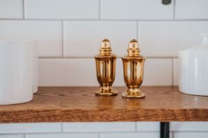 Brass shakers on a walnut shelf